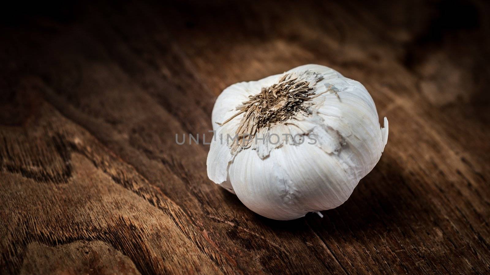 garlic on brown textured wood