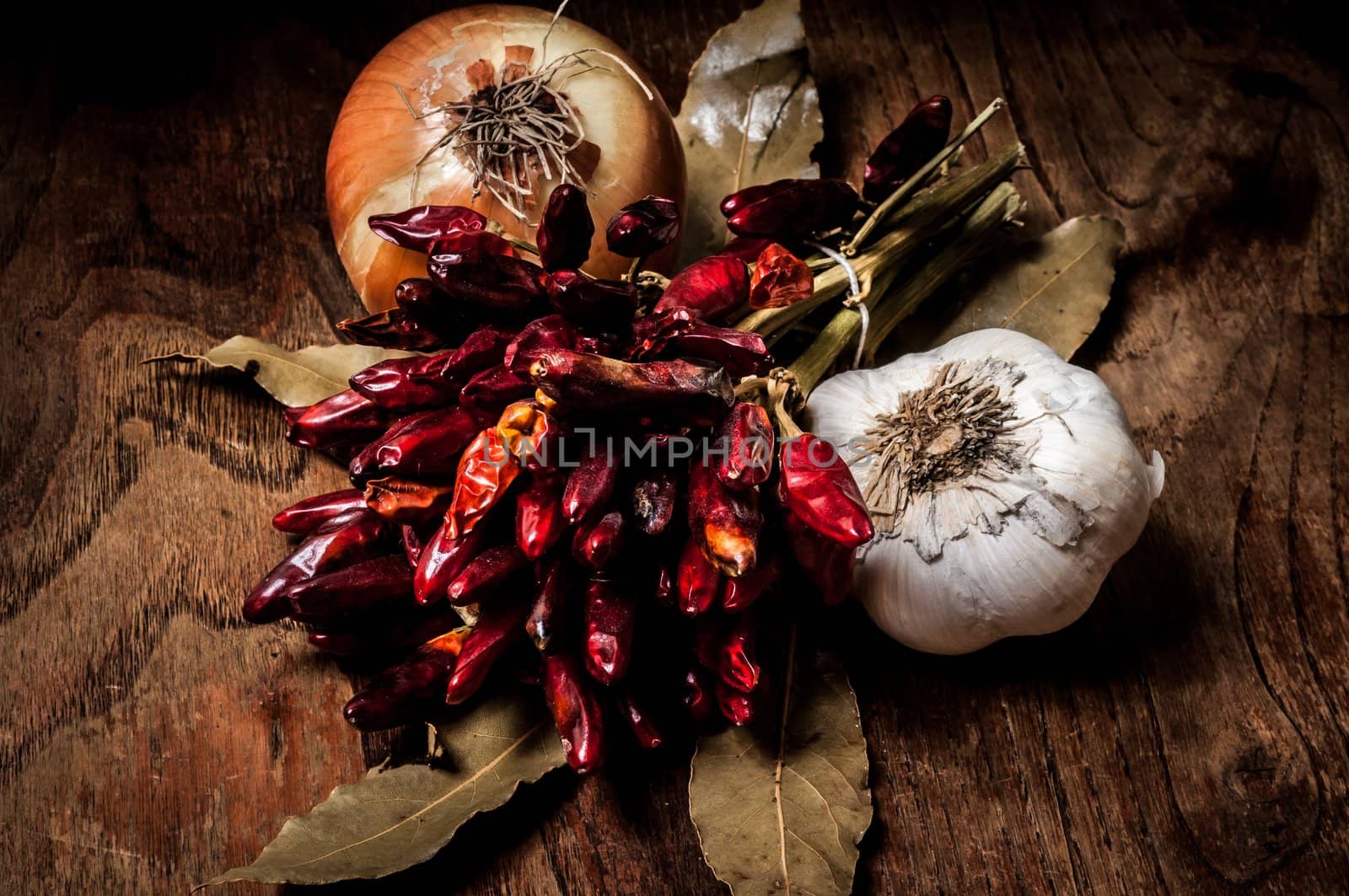 composition of chilies, onion and garlic on wood