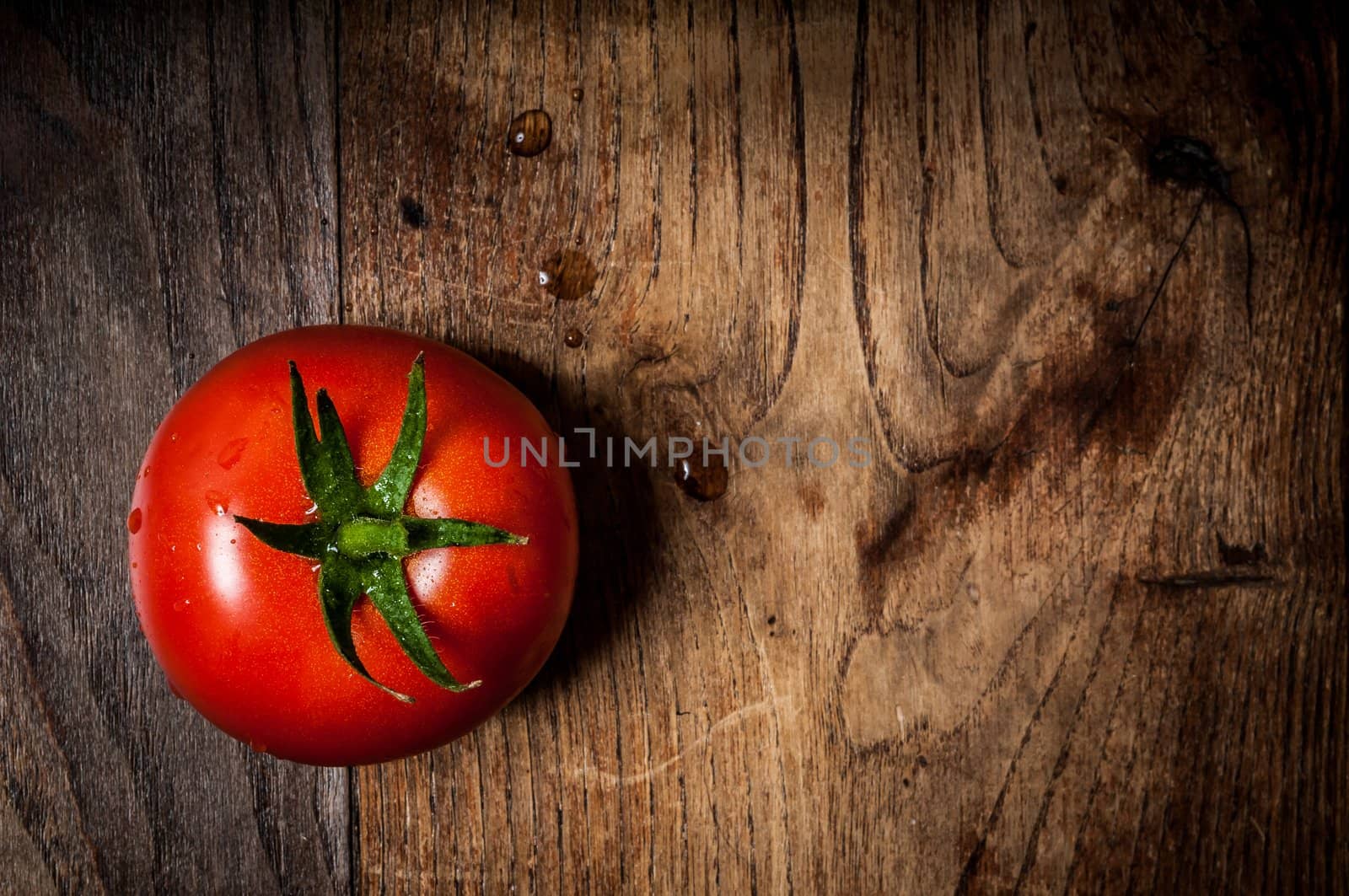 tomato on brown textured wood