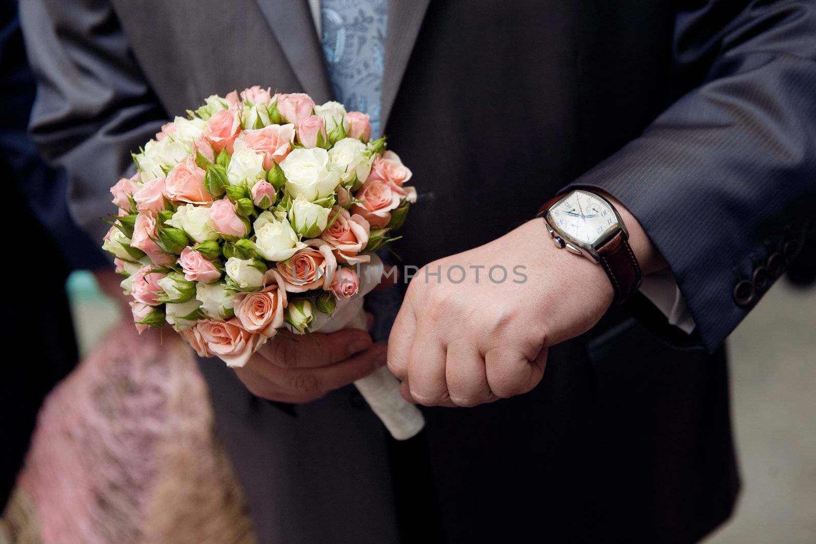 man with watch hands a flower bouquet by vsurkov