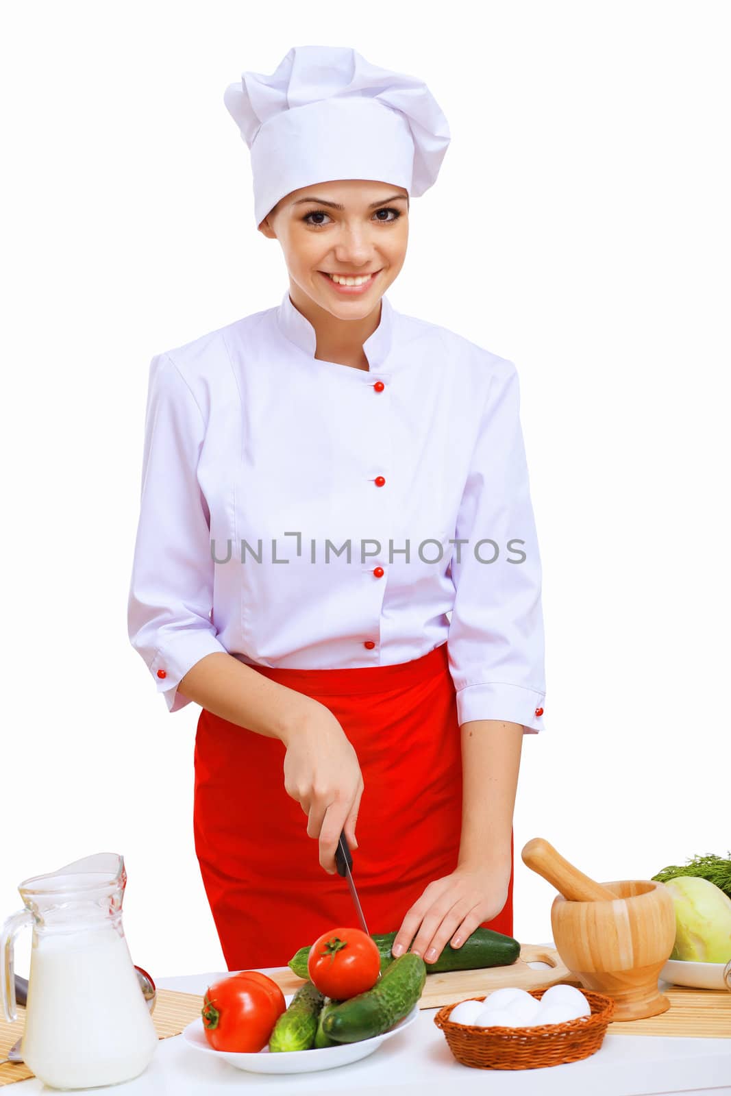 Young cook preparing food wearing a red apron