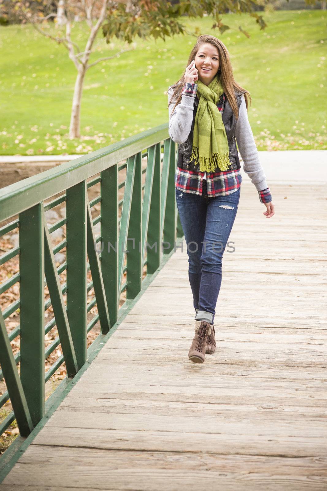 Attractive Mixed Race Attractive Woman Using Cell Phone Outside.