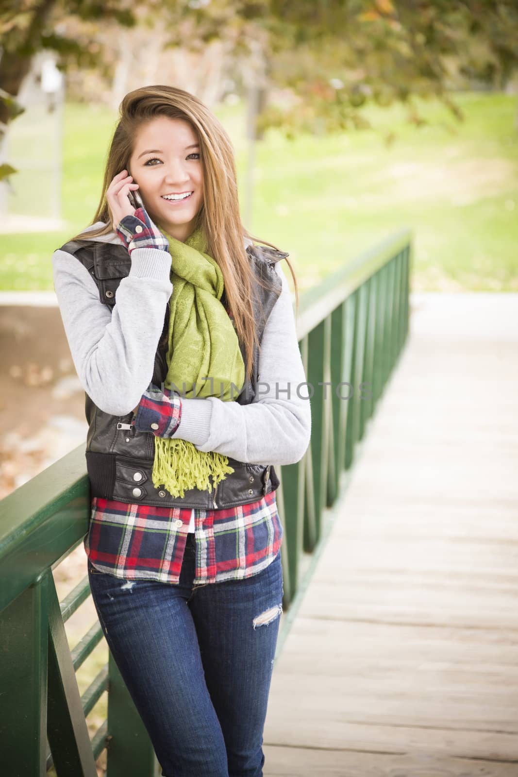 Attractive Mixed Race Attractive Woman Using Cell Phone Outside.