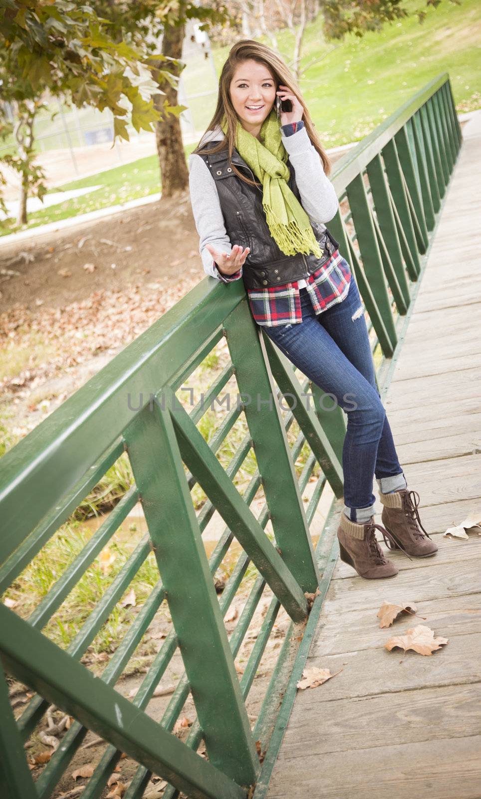 Attractive Mixed Race Attractive Woman Using Cell Phone Outside.