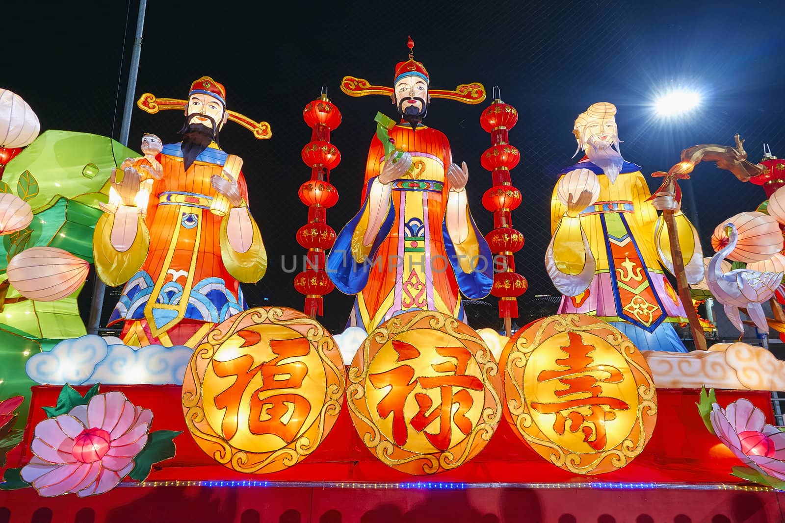 Chinese New Year God of Prosperity Good Fortune and Longevity Statues with Text Symbol Lit at Night