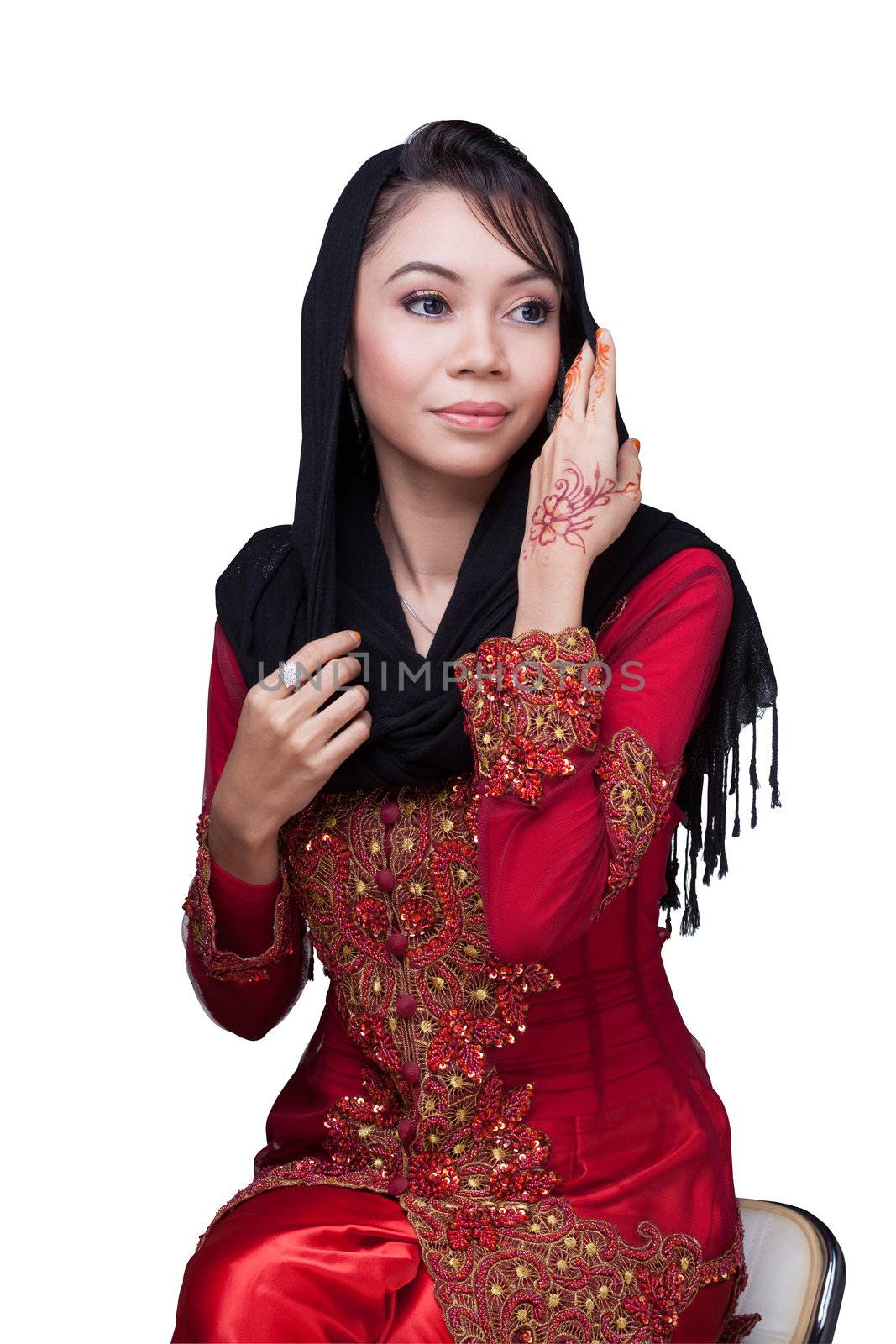 Beautiful muslim lady wear red with hijab, henna painted on hand