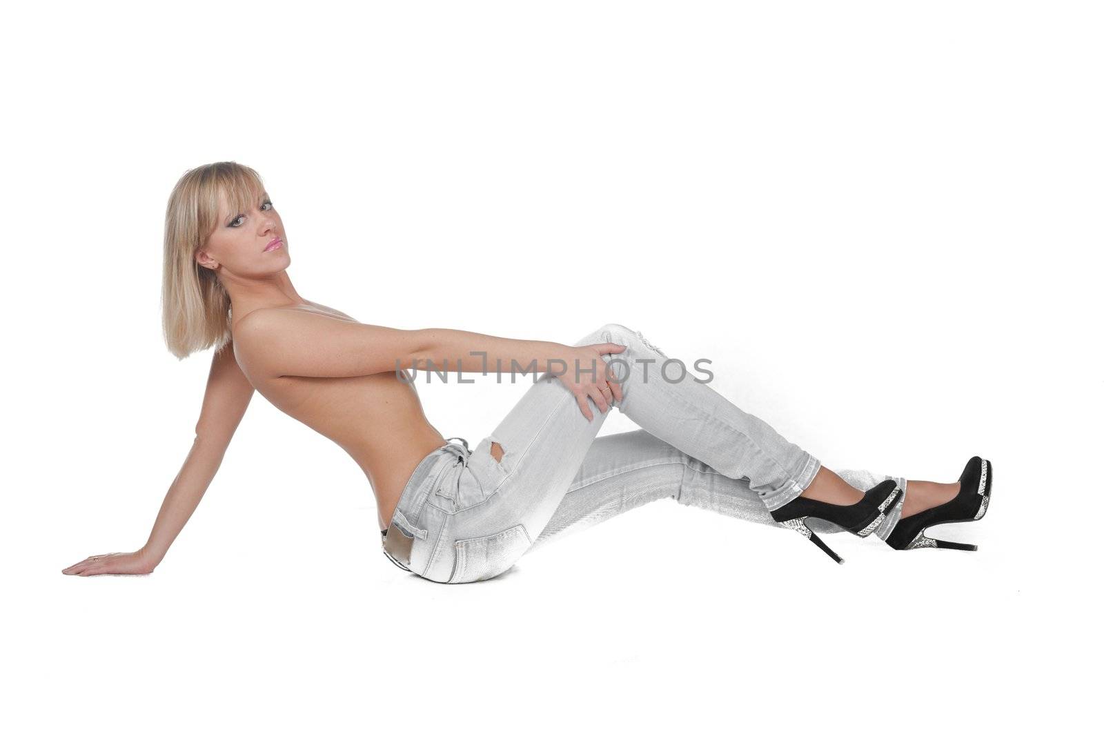 woman in jeans sitting isolated on white