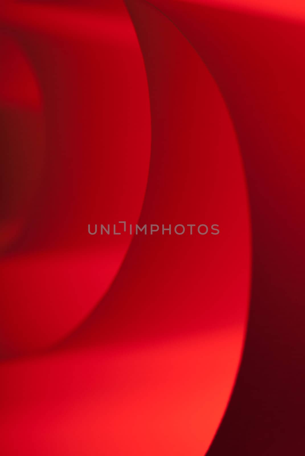 Spiraled red paper with a texture under soft light