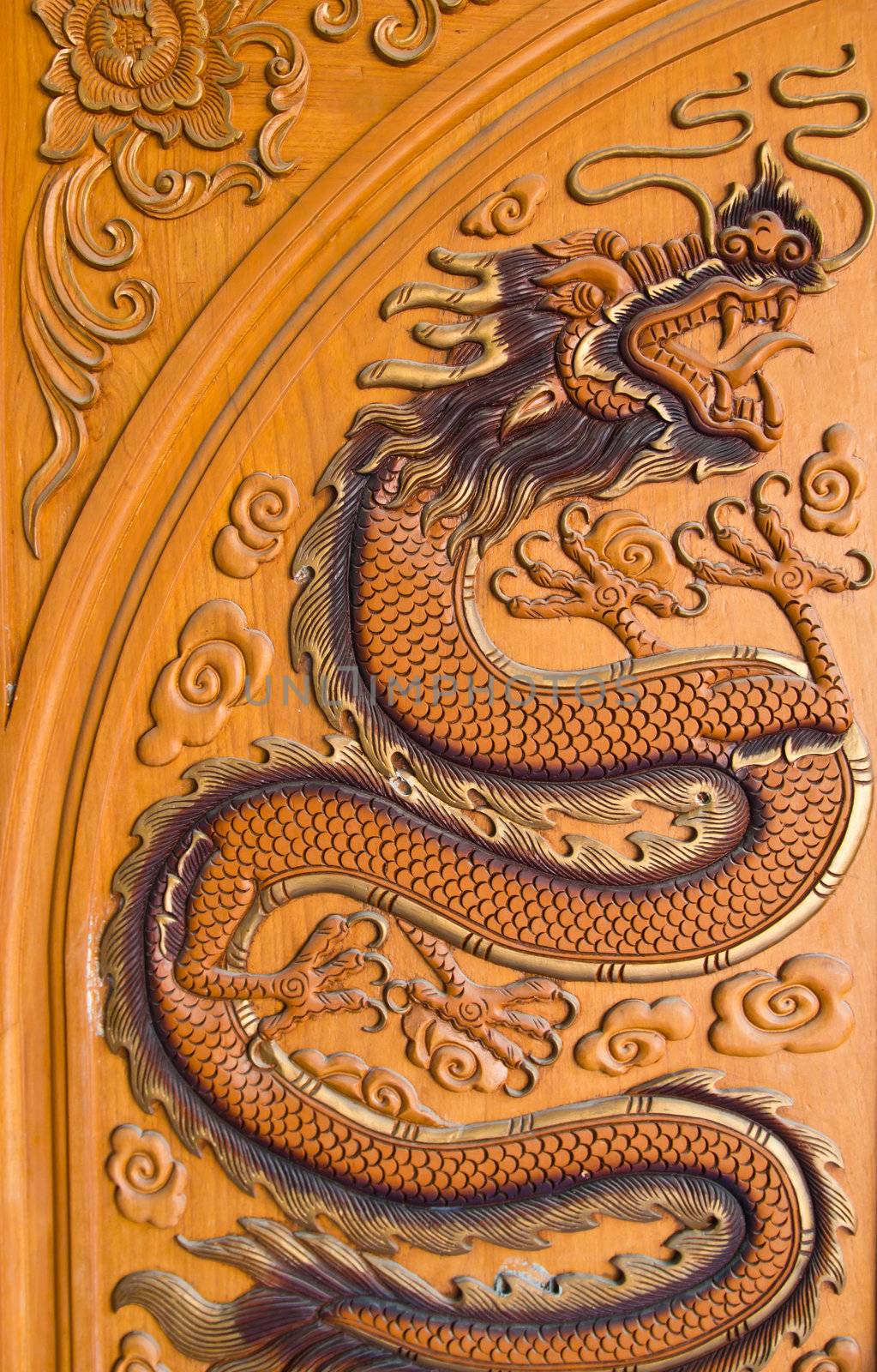 wood carving of a dragon at thailand by wasan_gredpree