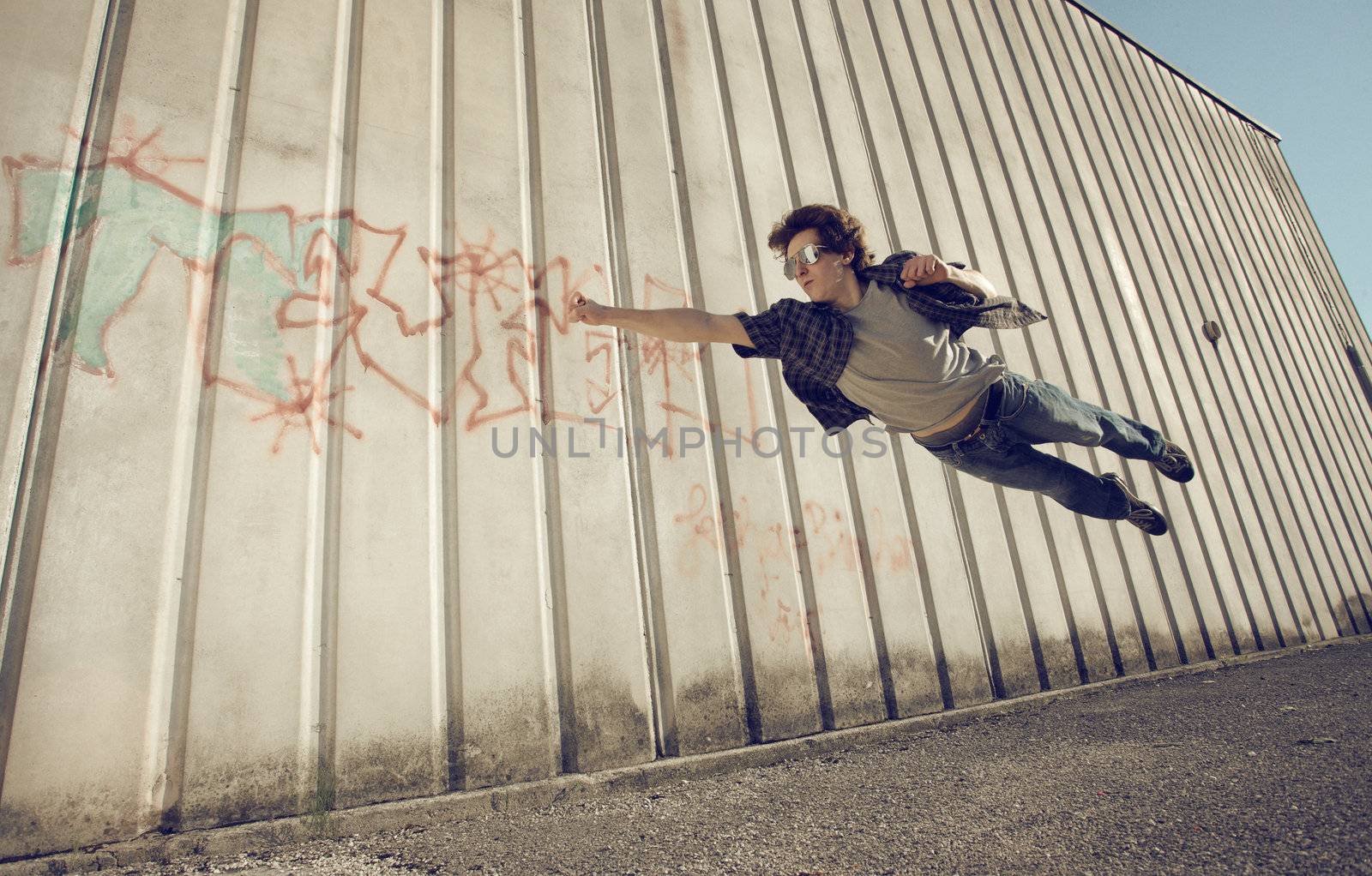 Young man feels like a superhero, flying free.