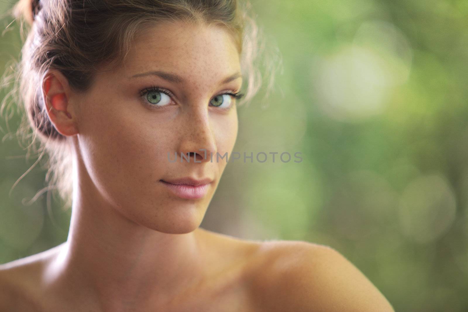 Portrait close up of young beautiful woman, on green background 