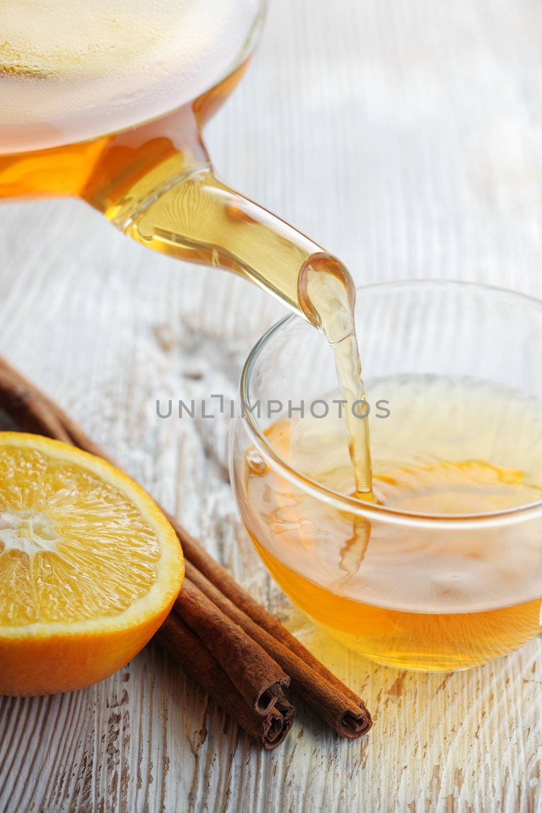 Pouring Tea into Glass Cup by stokkete