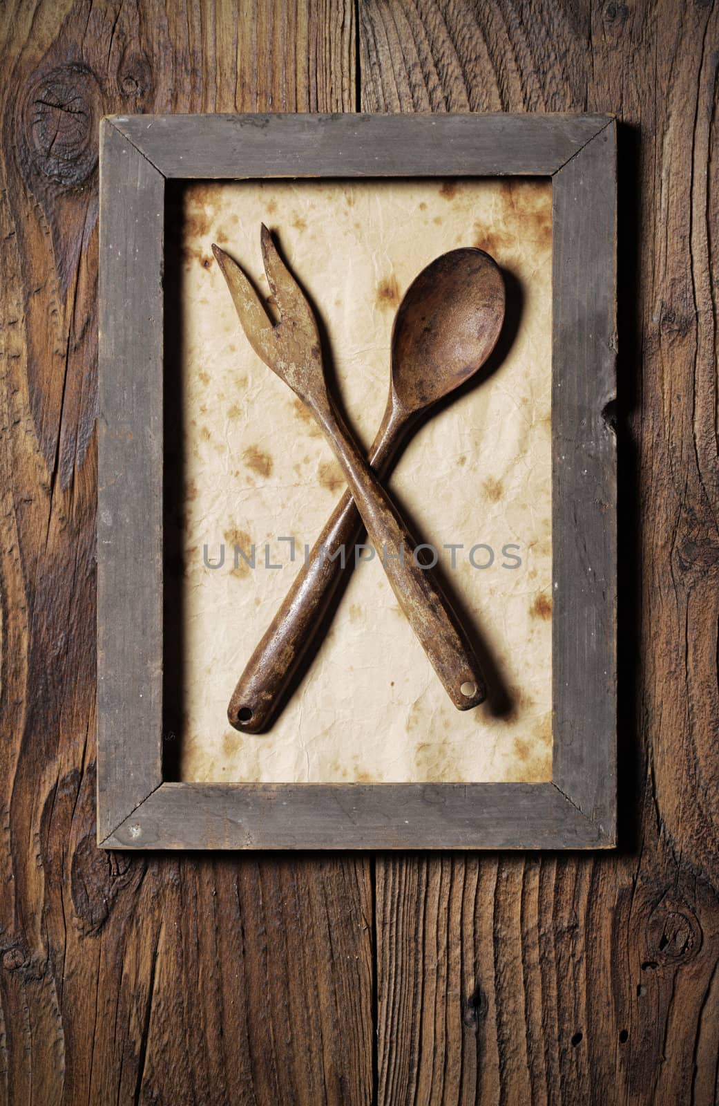 Fork and spoon wooden, framed by stokkete