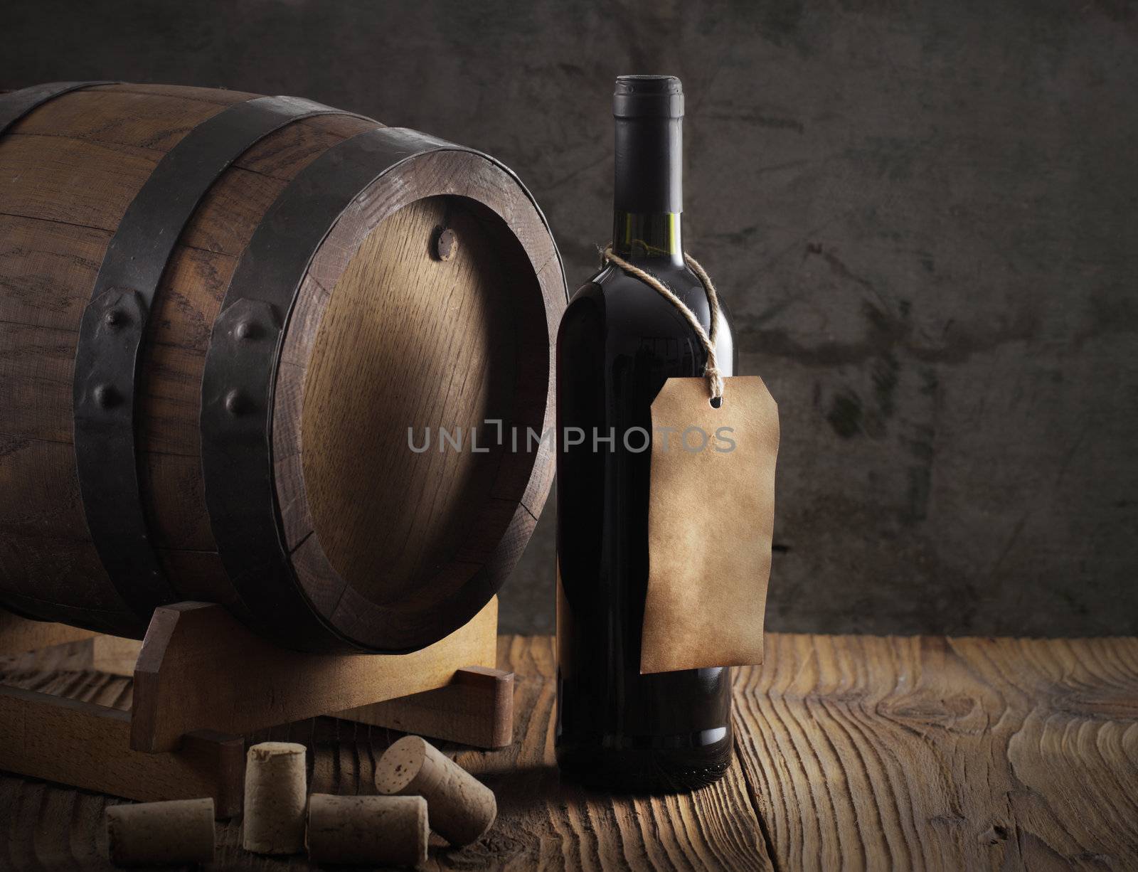 Red wine bottle and old barrel by stokkete
