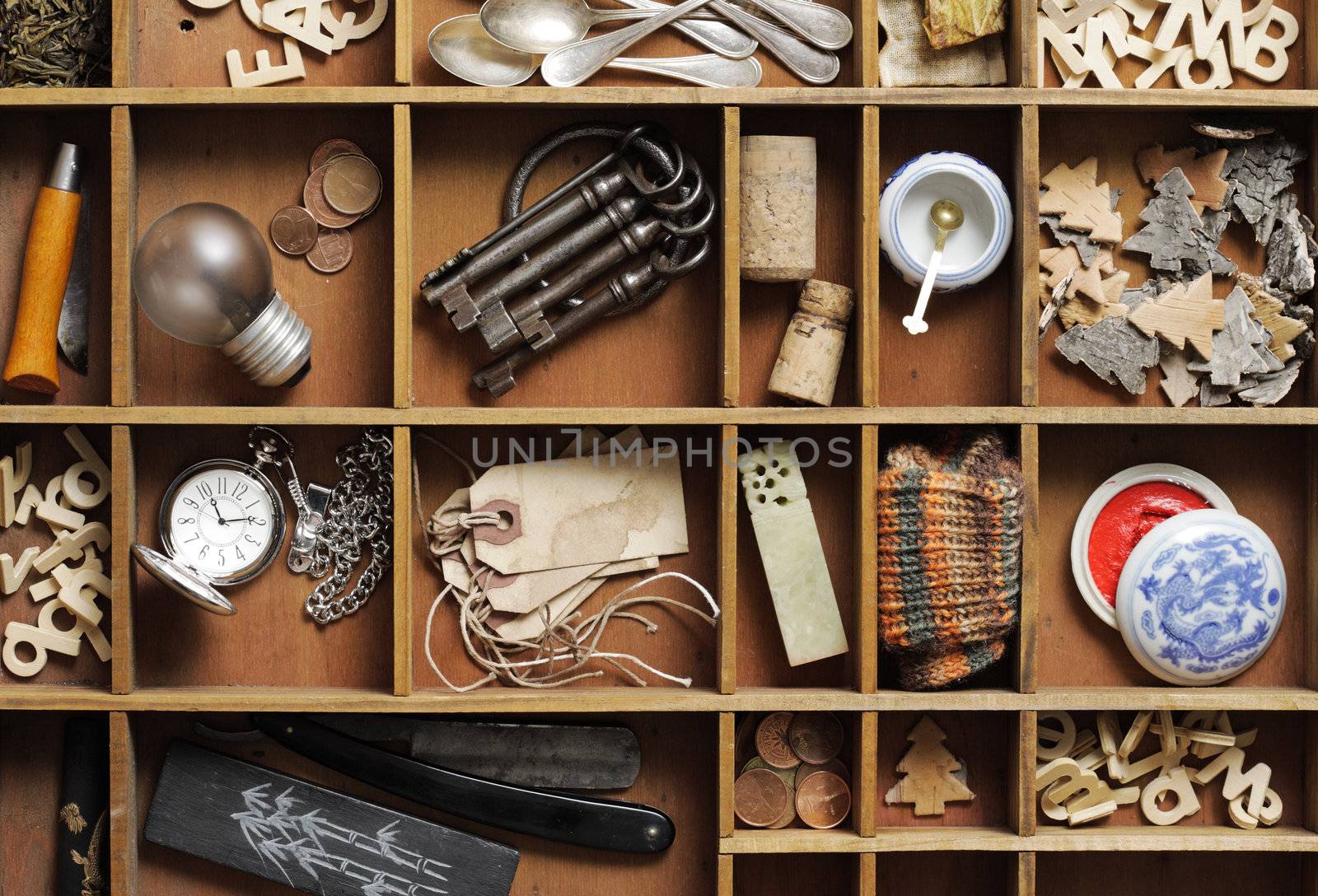 group of old objects in a drawer with compartments