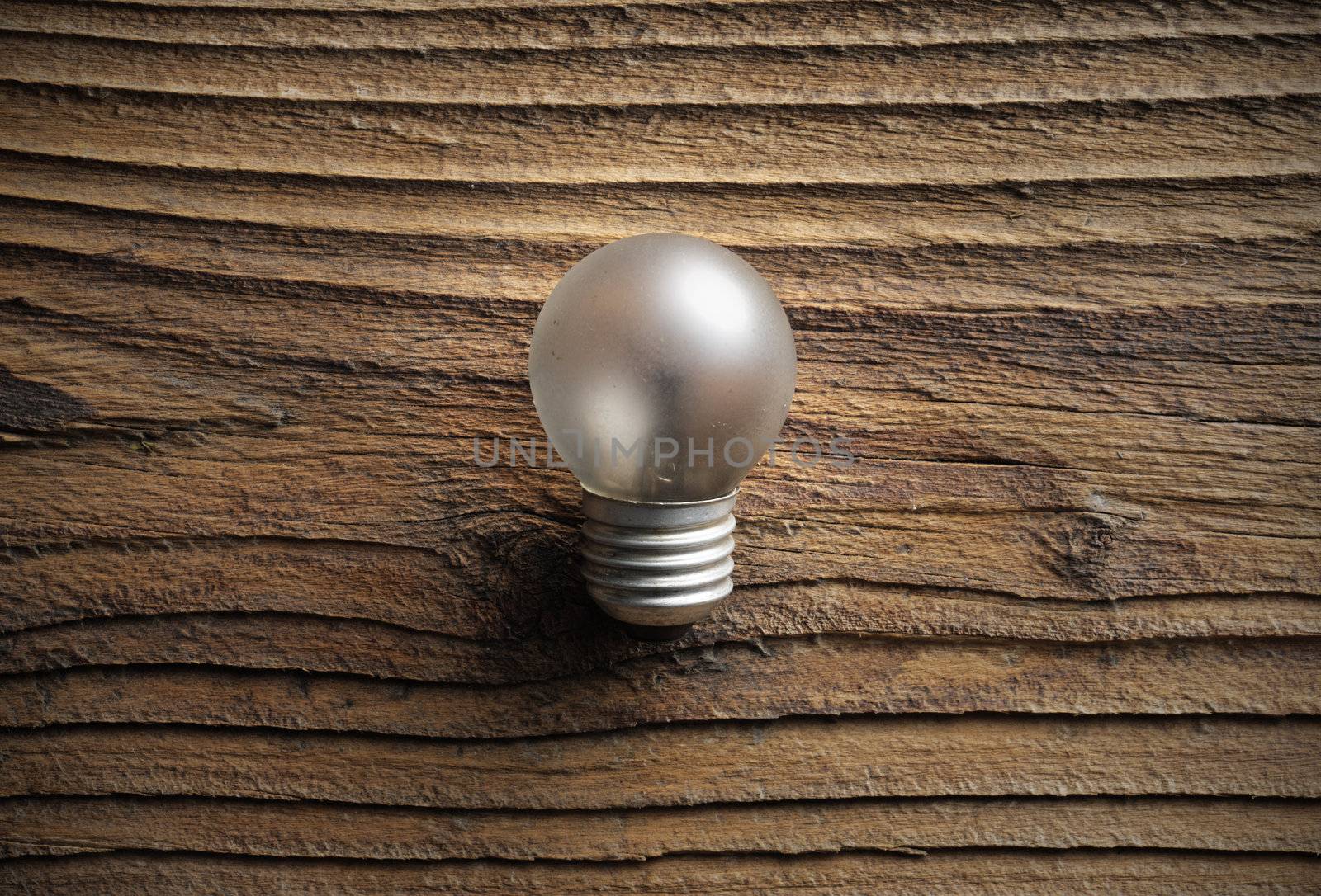 old light bulb on wooden background
