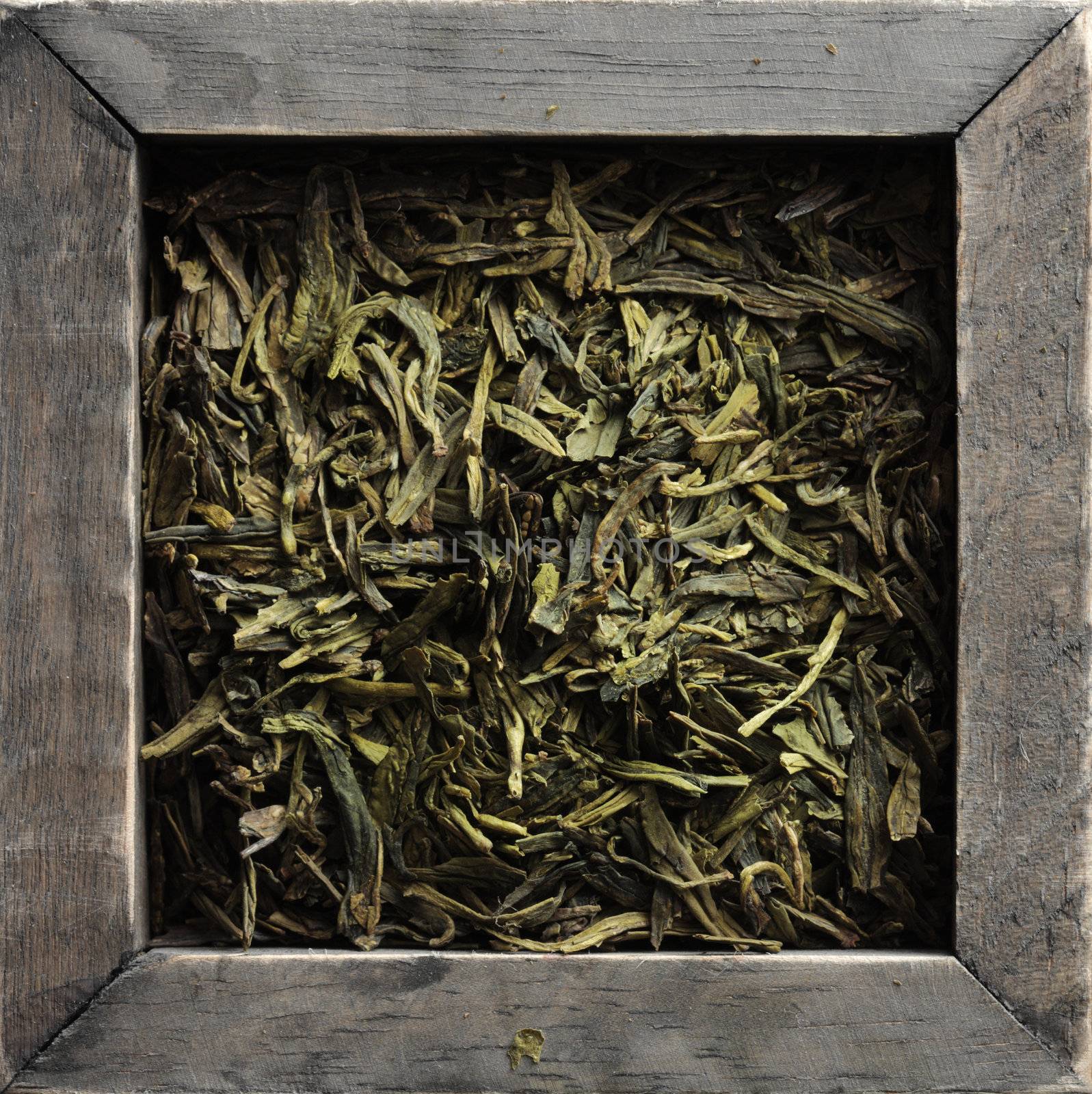 Pile of jasmine green tea in a wooden box