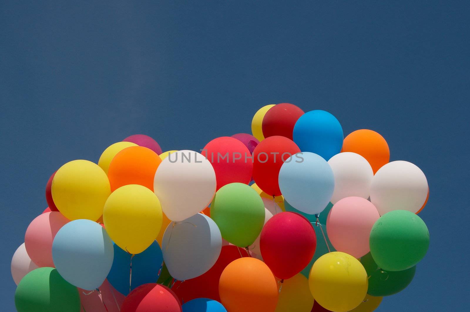 colorful balloons flying in blue sky by fotosergio