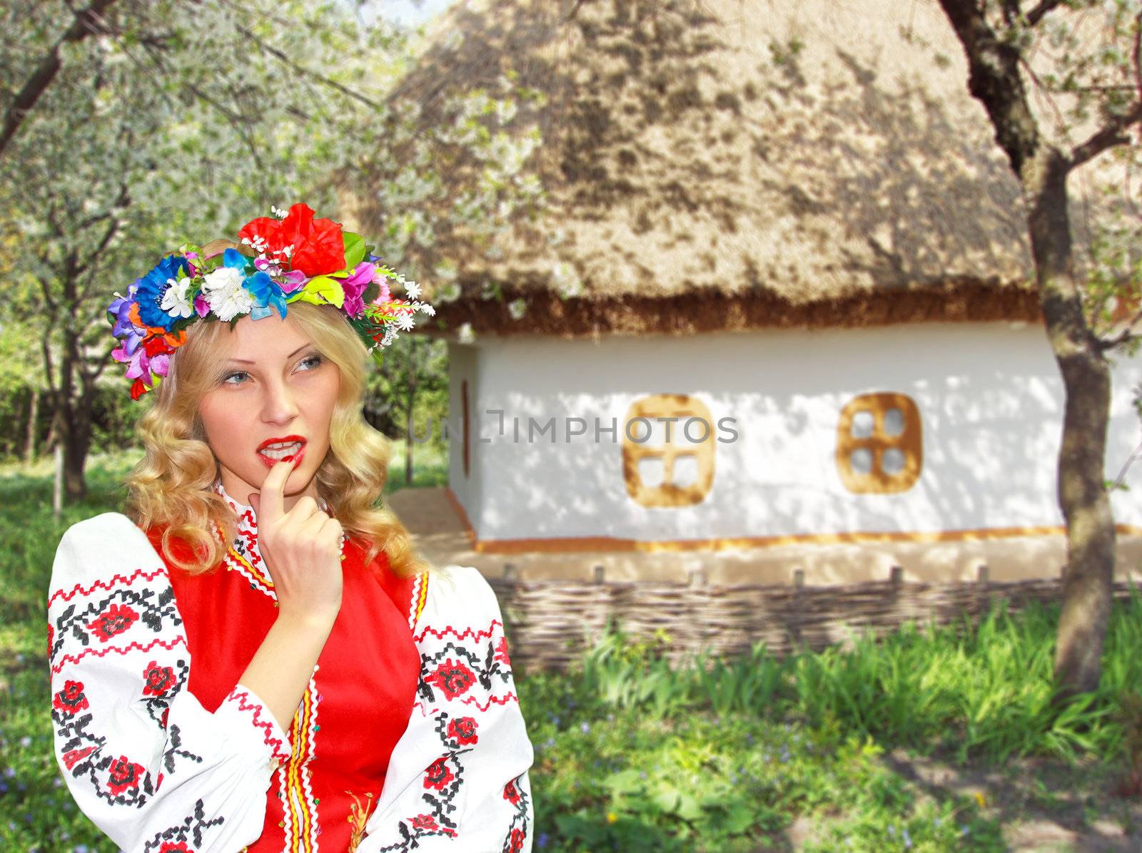 Beautiful girl in the Ukrainian national costume in garden near  by NickNick