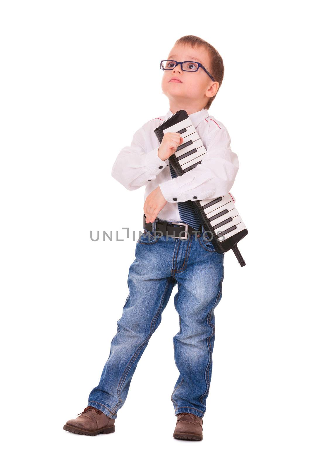Preschool boy in glasses, jeans and white shirt with melodica, isolated on white background