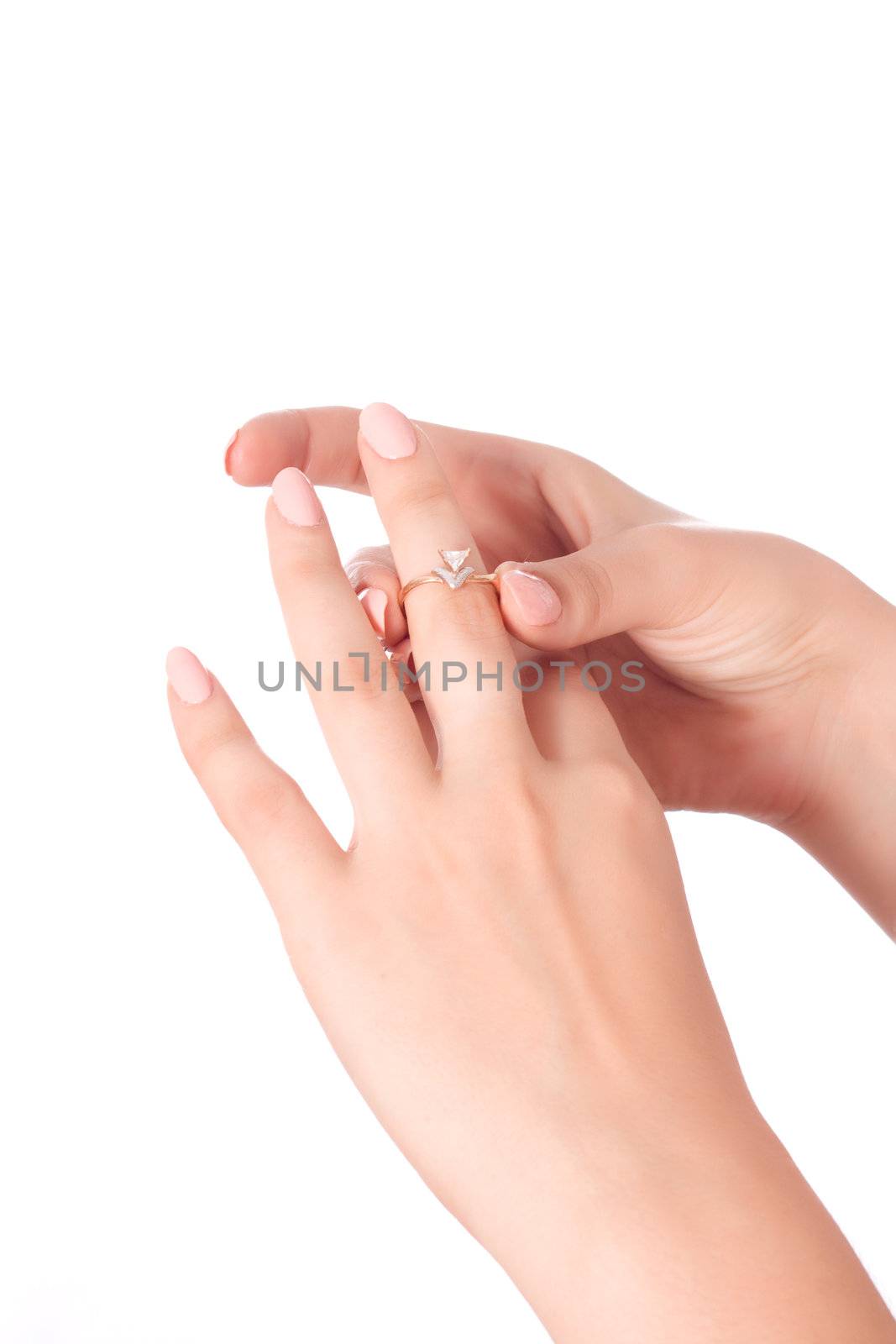 woman tries on a gold ring with diamonds isolated on white background