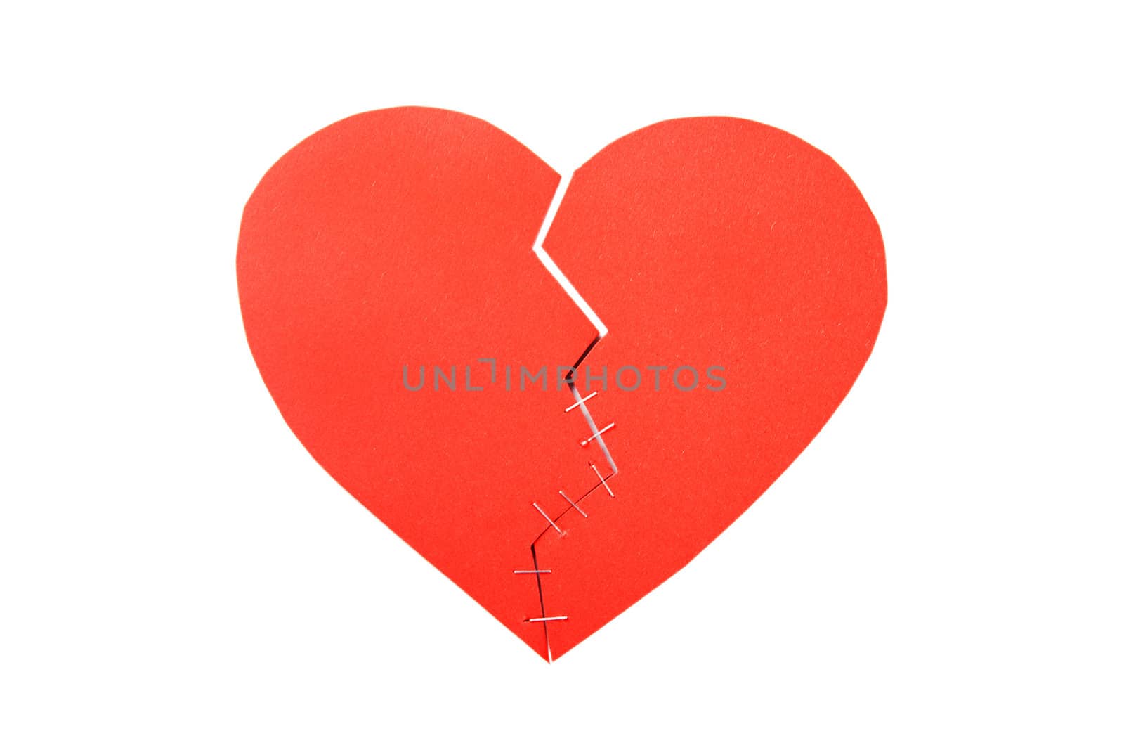 Broken cardboard heart isolated on white background