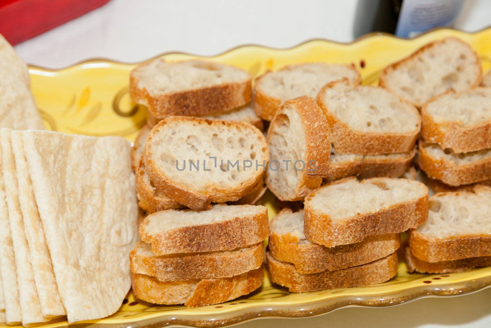 Basket full of various bread slices on a table.