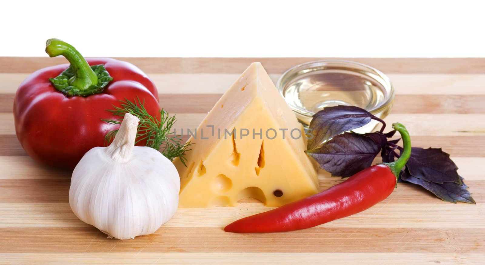 cheese and paprika on wooden board