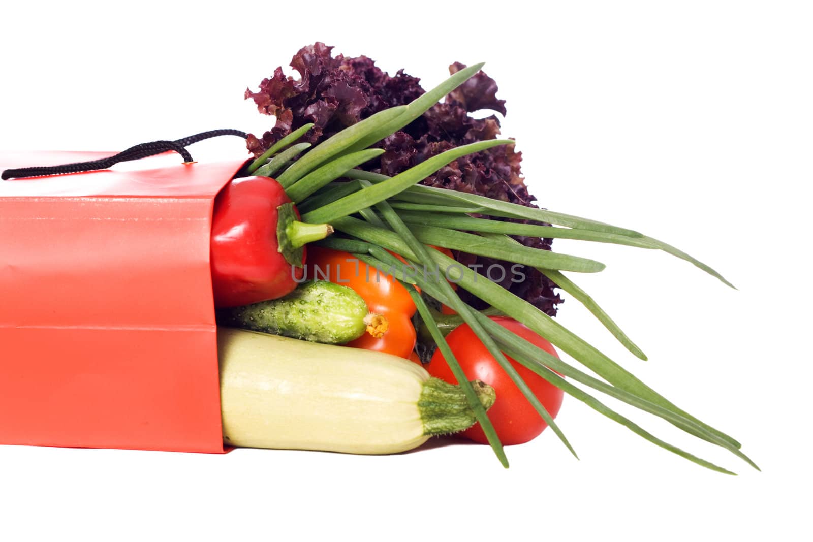 grocery bag full of vegetables isolated on white background