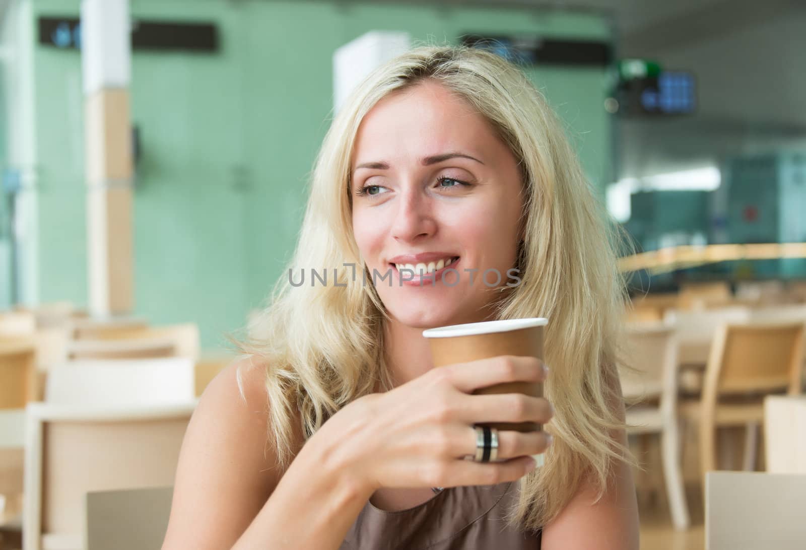 Portrait of smiling beautiful woman having cup of coffee
