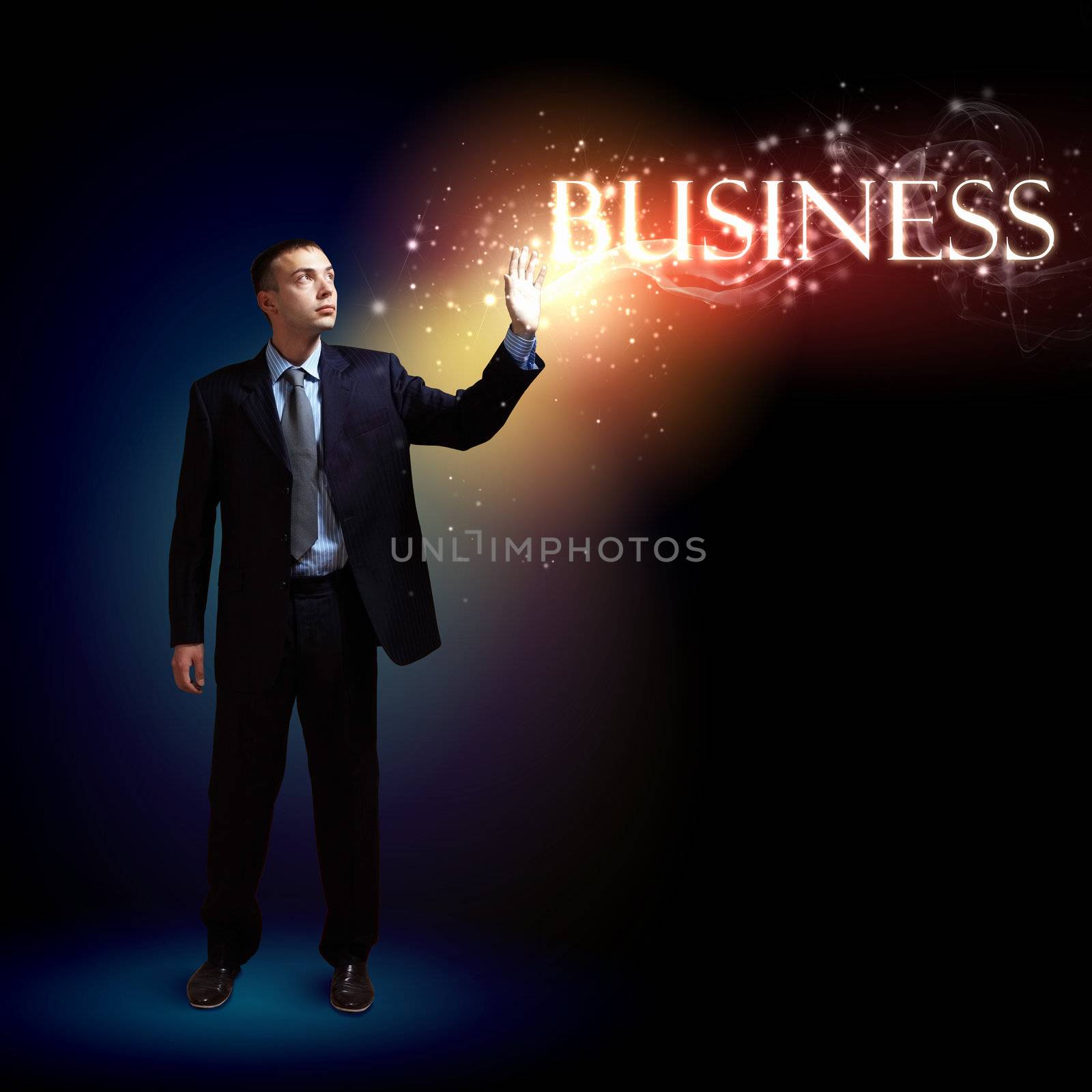 Young successful businessman holding a shining light in his hand as a symbol of success and advancement.