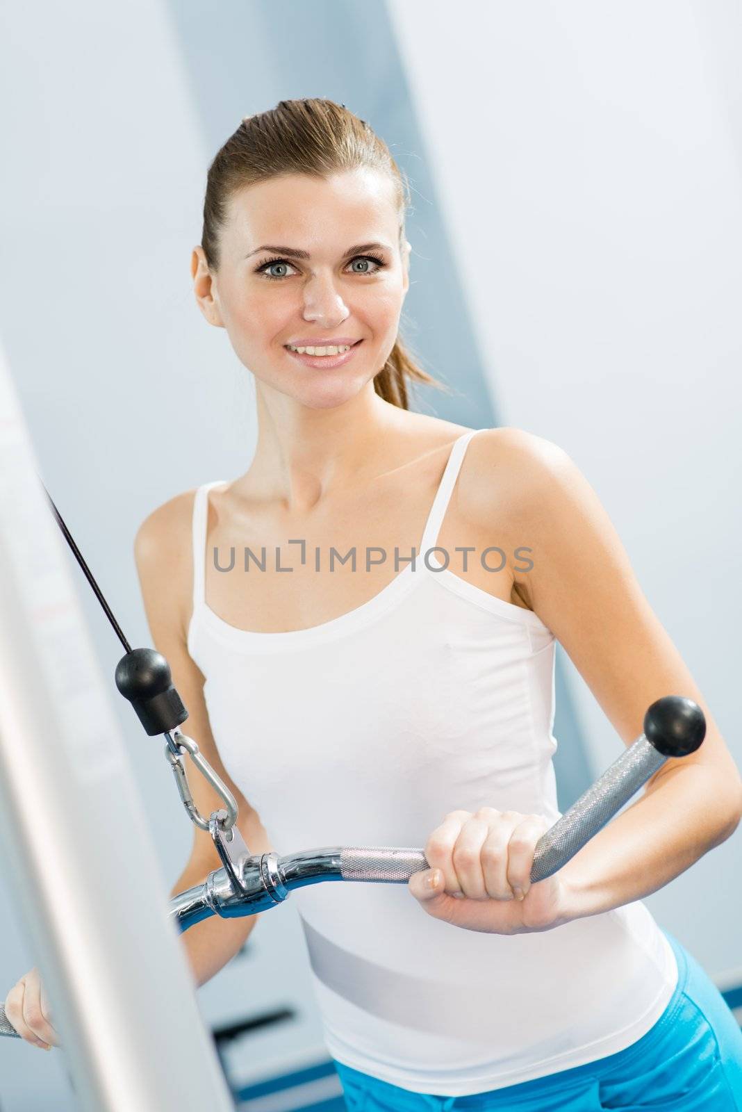 young woman doing body-building in the Gym, live a healthy life