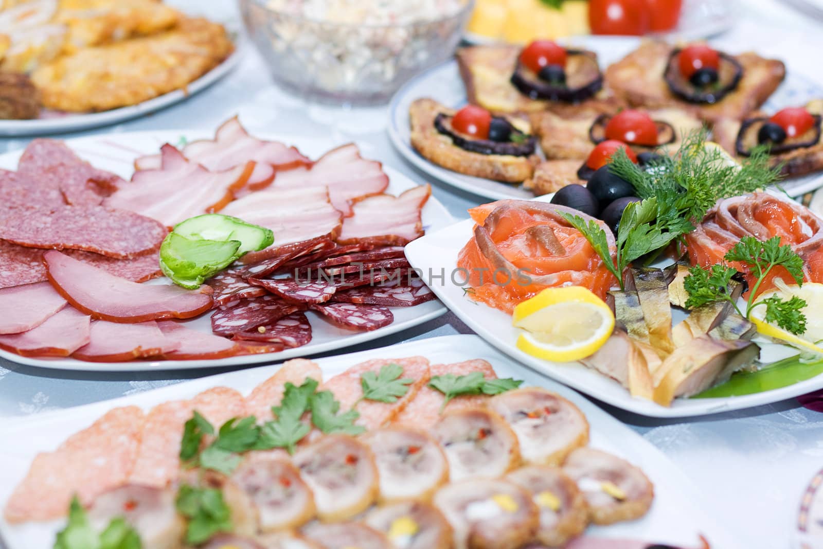 Sliced sausage, served on plates on the festive table