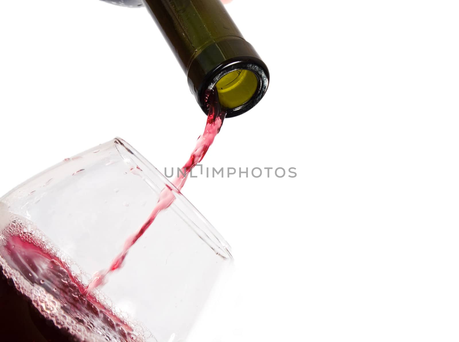 red wine pouring into wine glass isolated