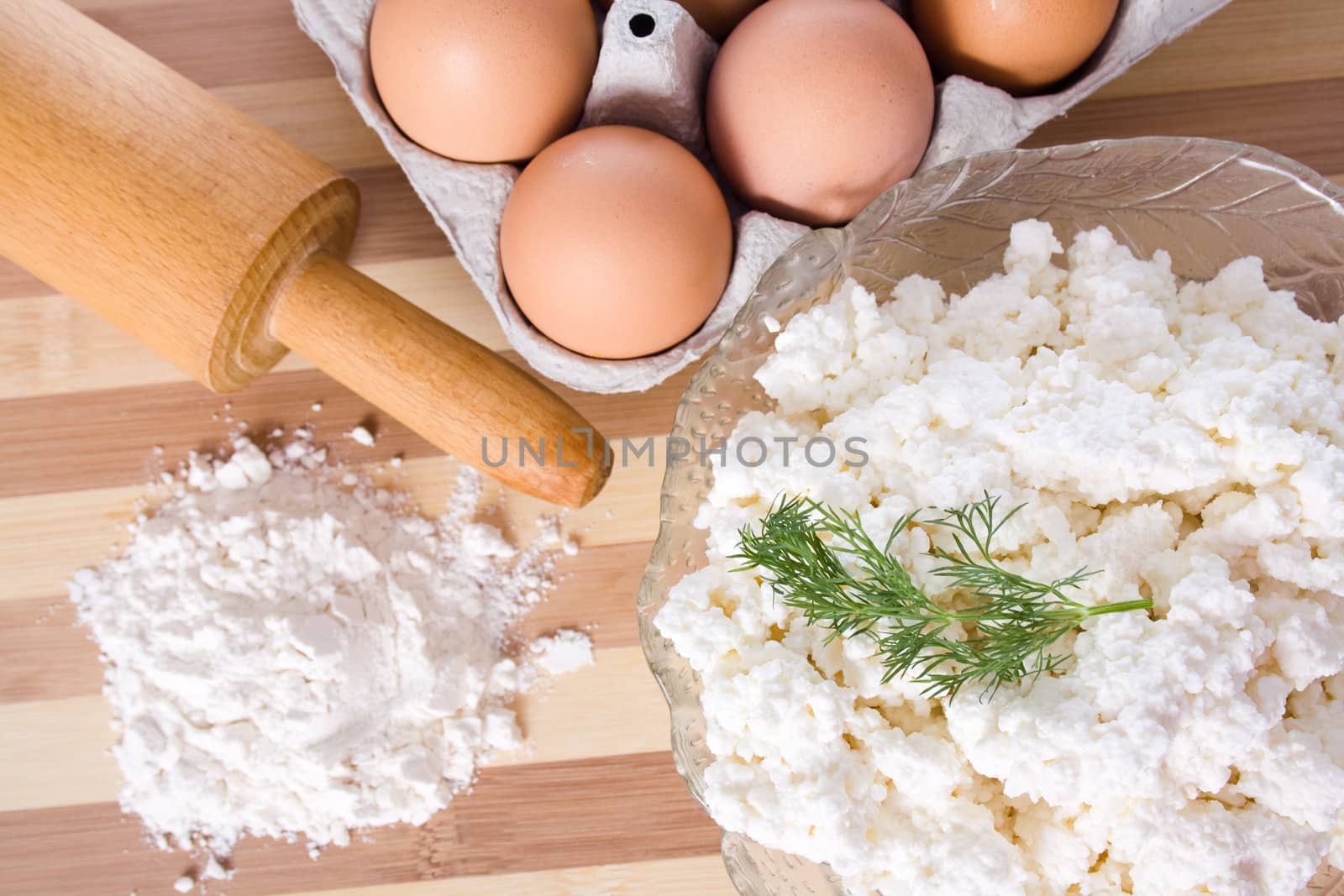 Baking ingredients, milk, flour, eggs and cheese on the table