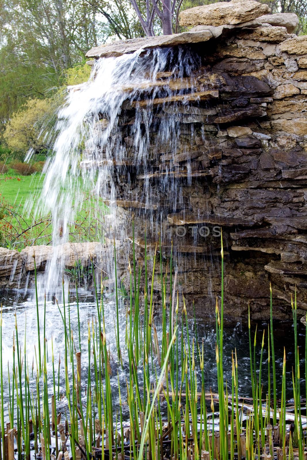 stone structure with a waterfall. Fountain in City Park