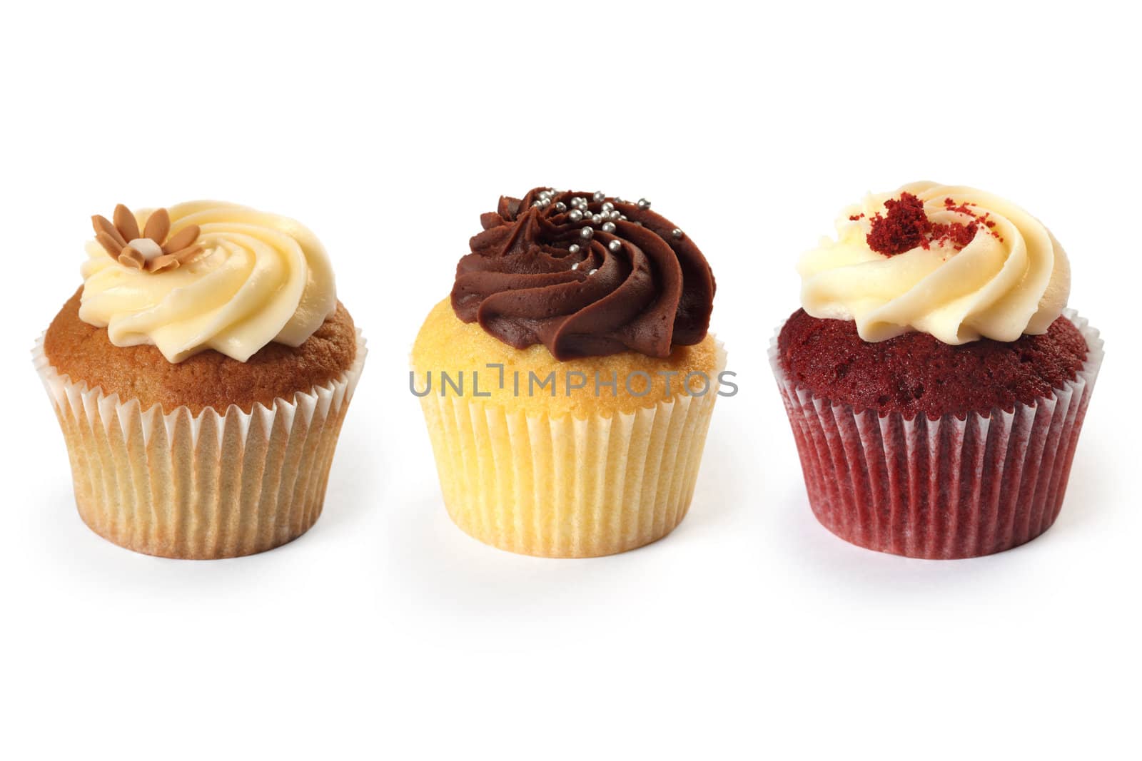 Photo of three different flavored cupcakes on white background.
