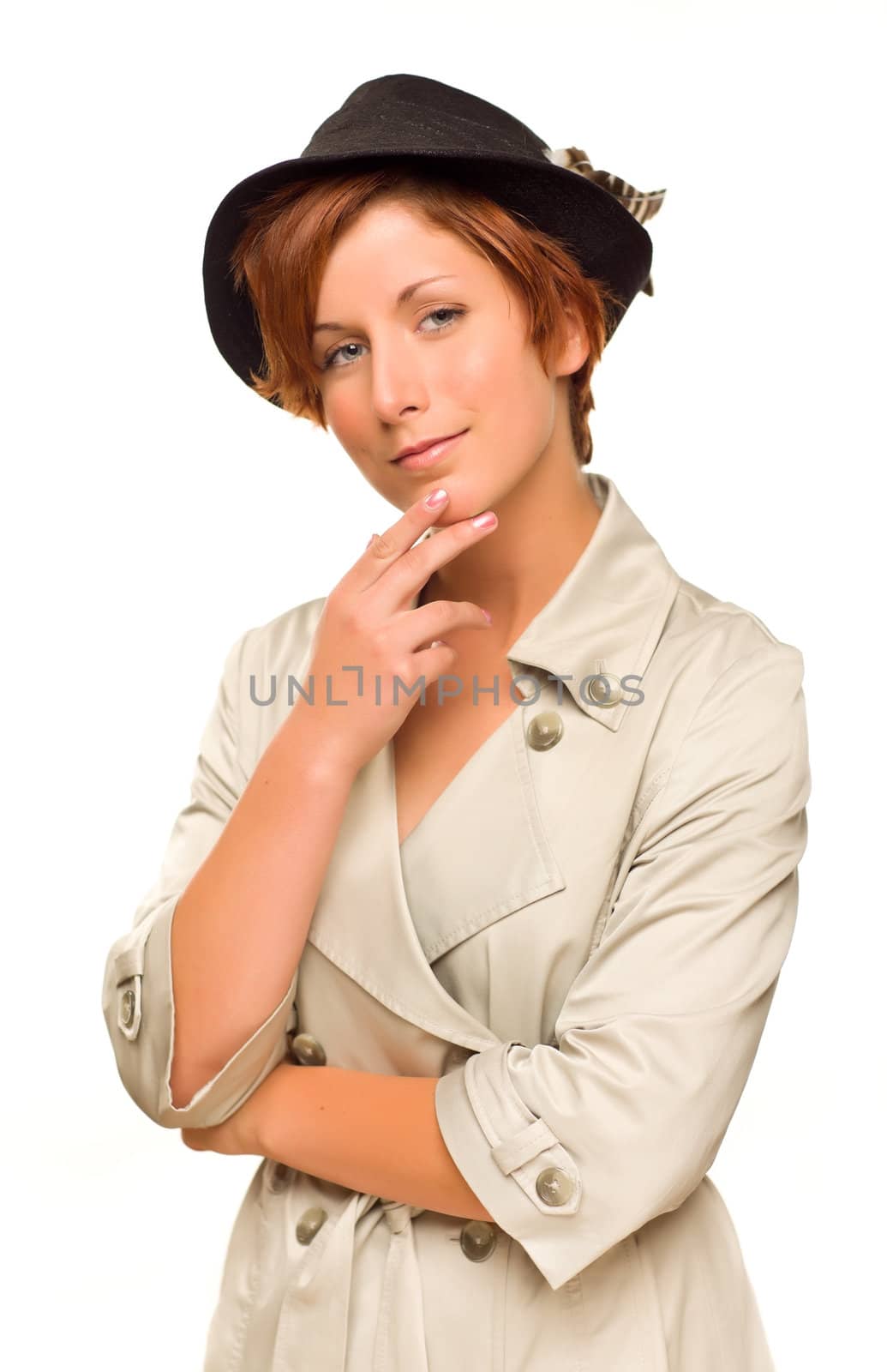 Attractive Red Haired Girl Wearing a Trenchcoat and Hat Isolated on a White Background.