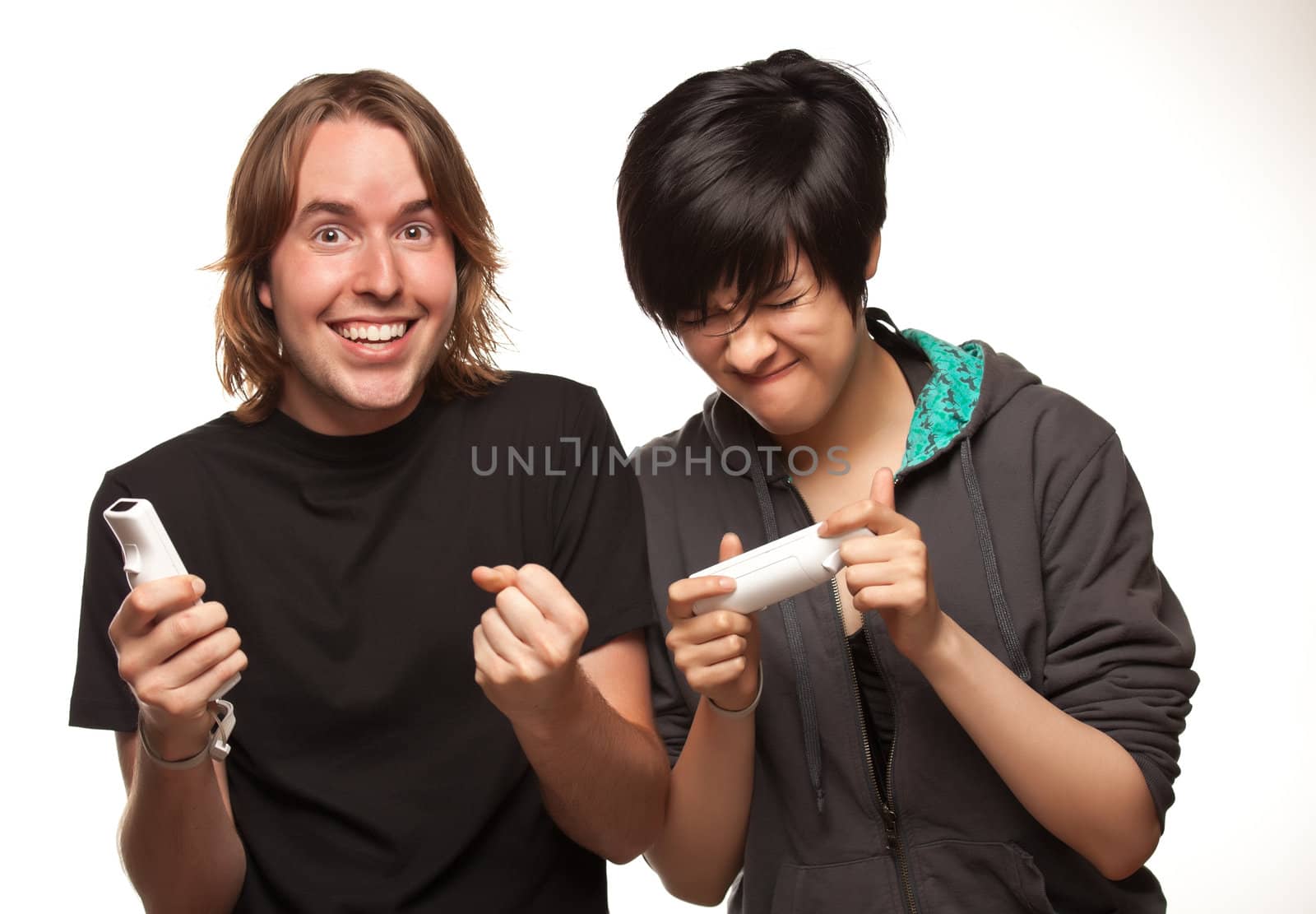 Fun Happy Mixed Race Couple Playing Video Game Remotes Isolated on a White Background.