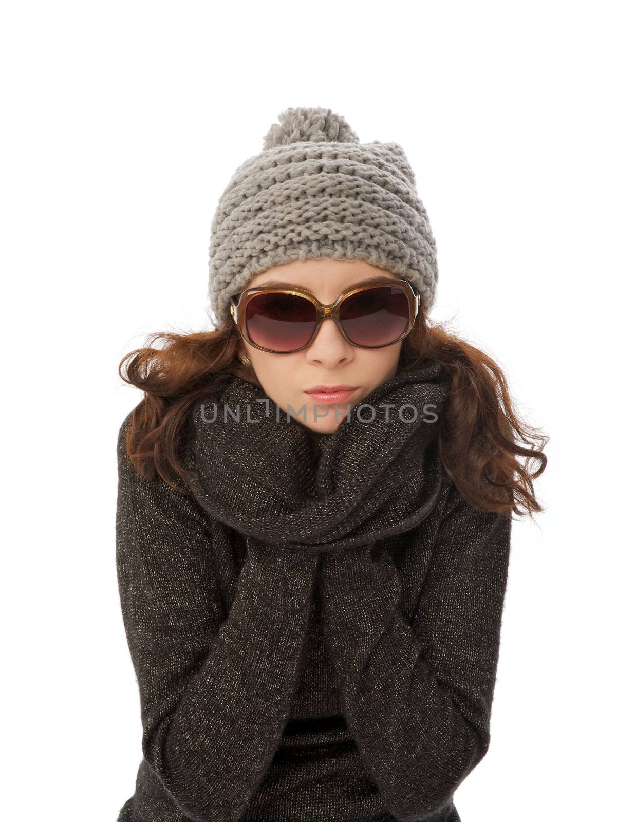 Beautiful Girl in Knitted Hat, Warm Sweater and Sunglasses Shiver with Cold  closeup on white background