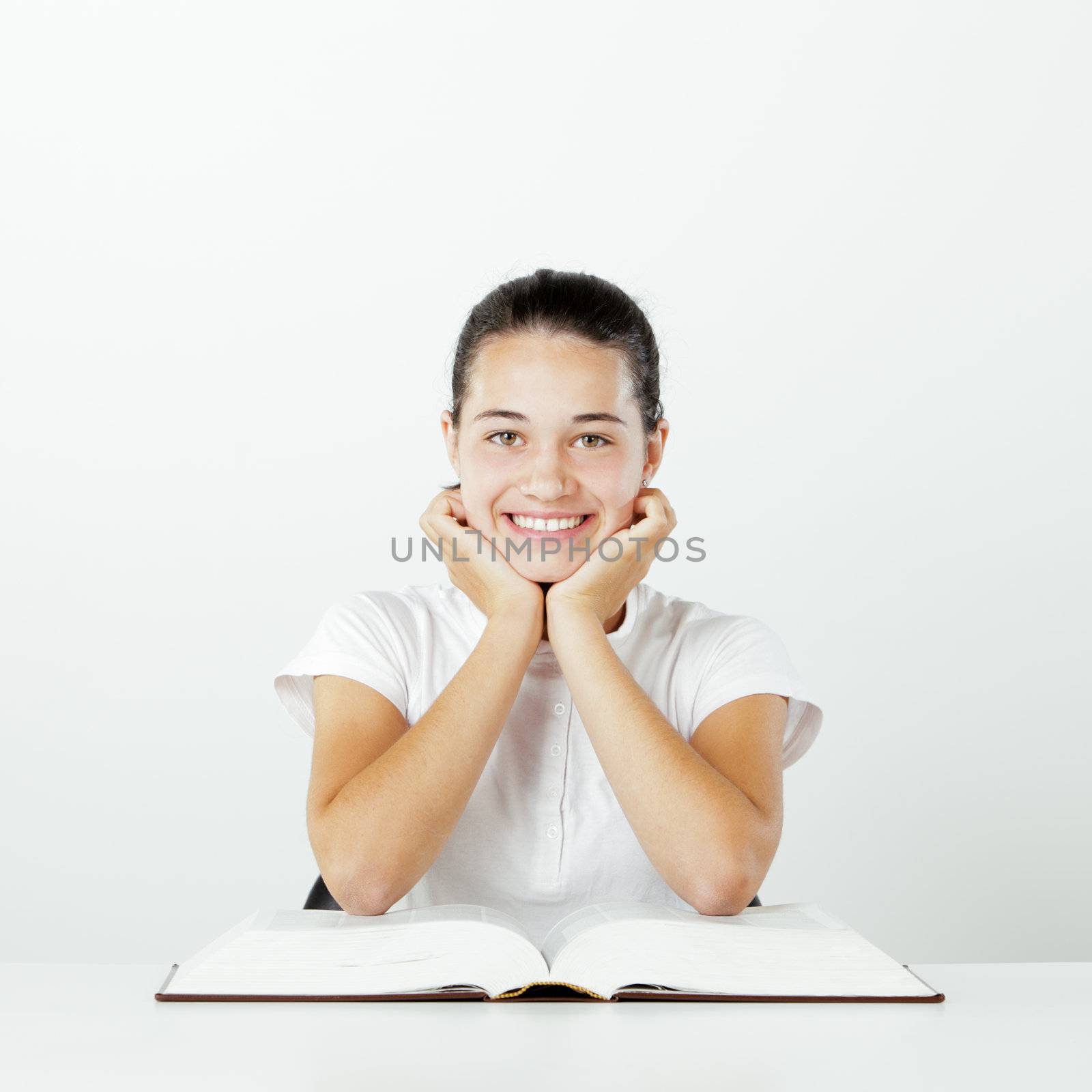 Young smiling  girl with open book
