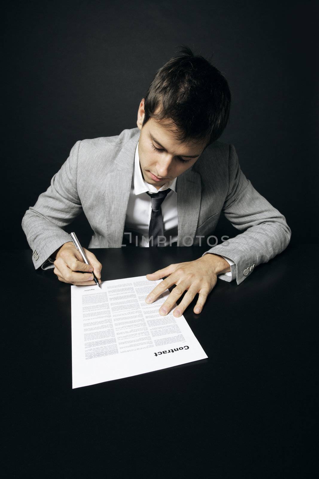 Businessman is signing a contract 