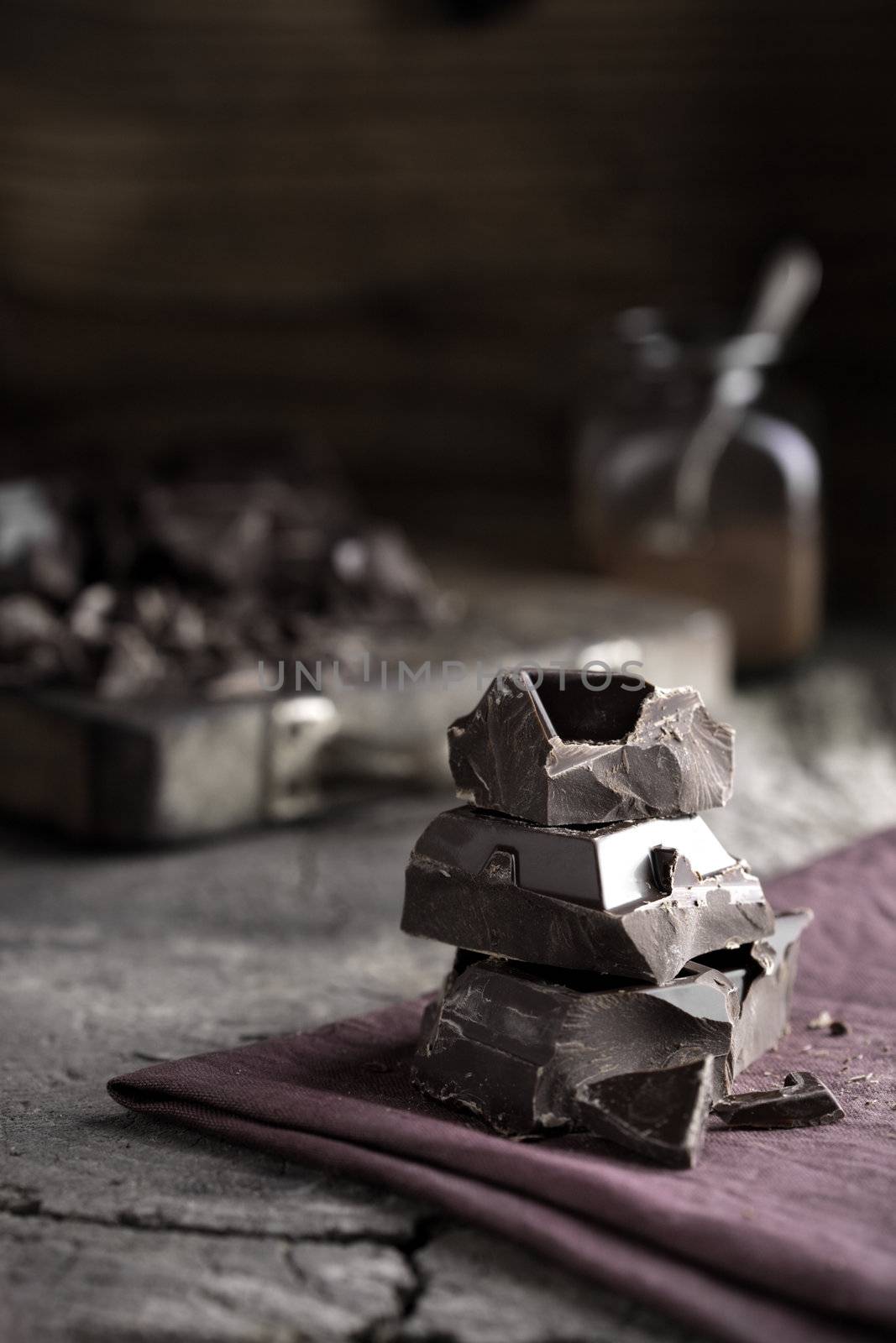 Stack of dark chocolate pieces on a napkin