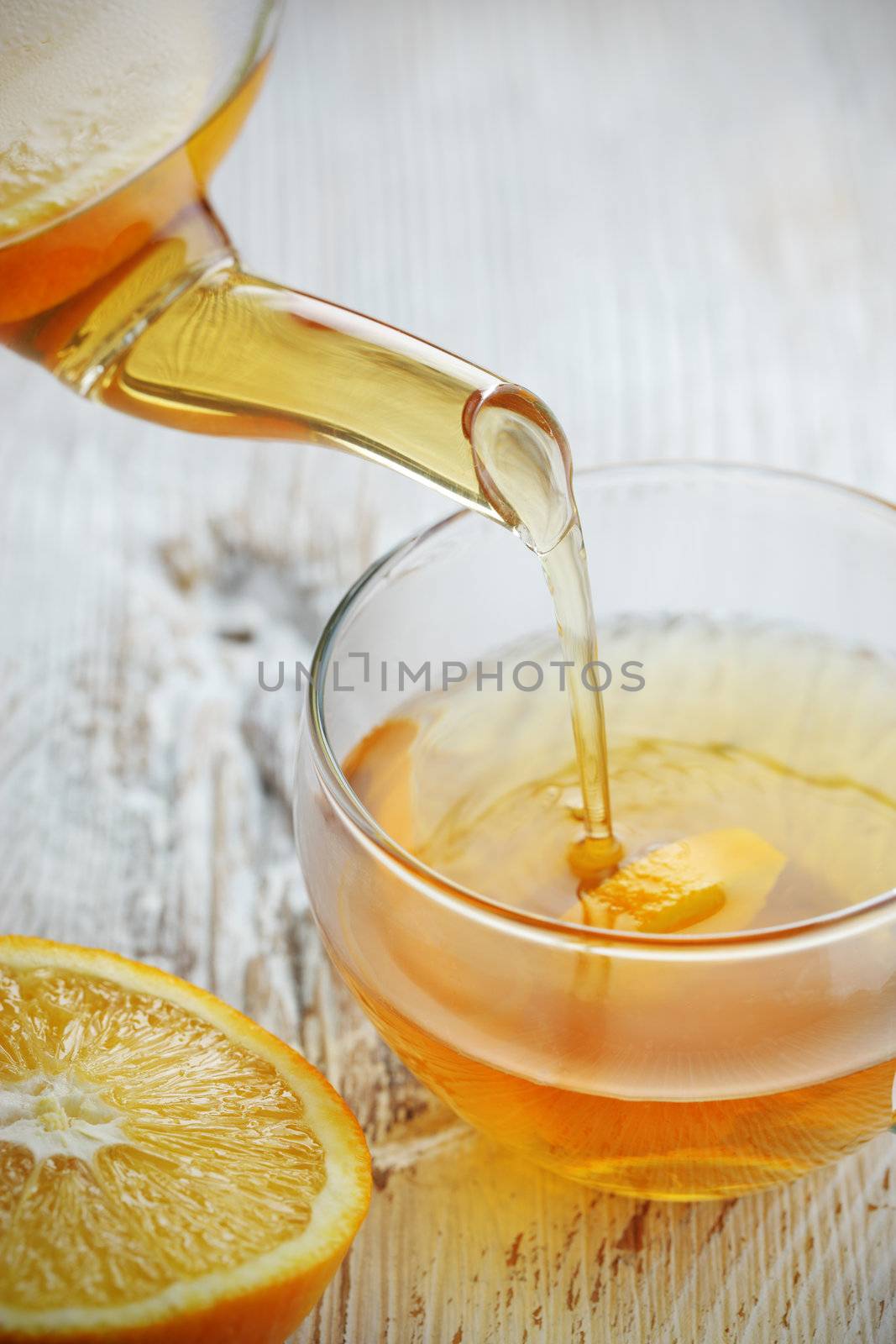 Pouring Tea into Glass Cup