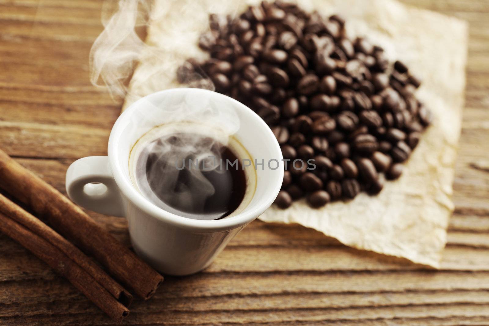 Smoking hot coffee with coffee beans by stokkete