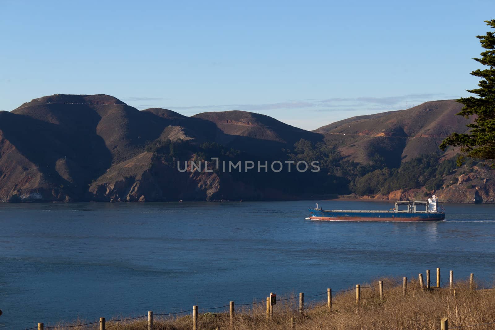 Cargo Ship near the coastline by bigjohn36