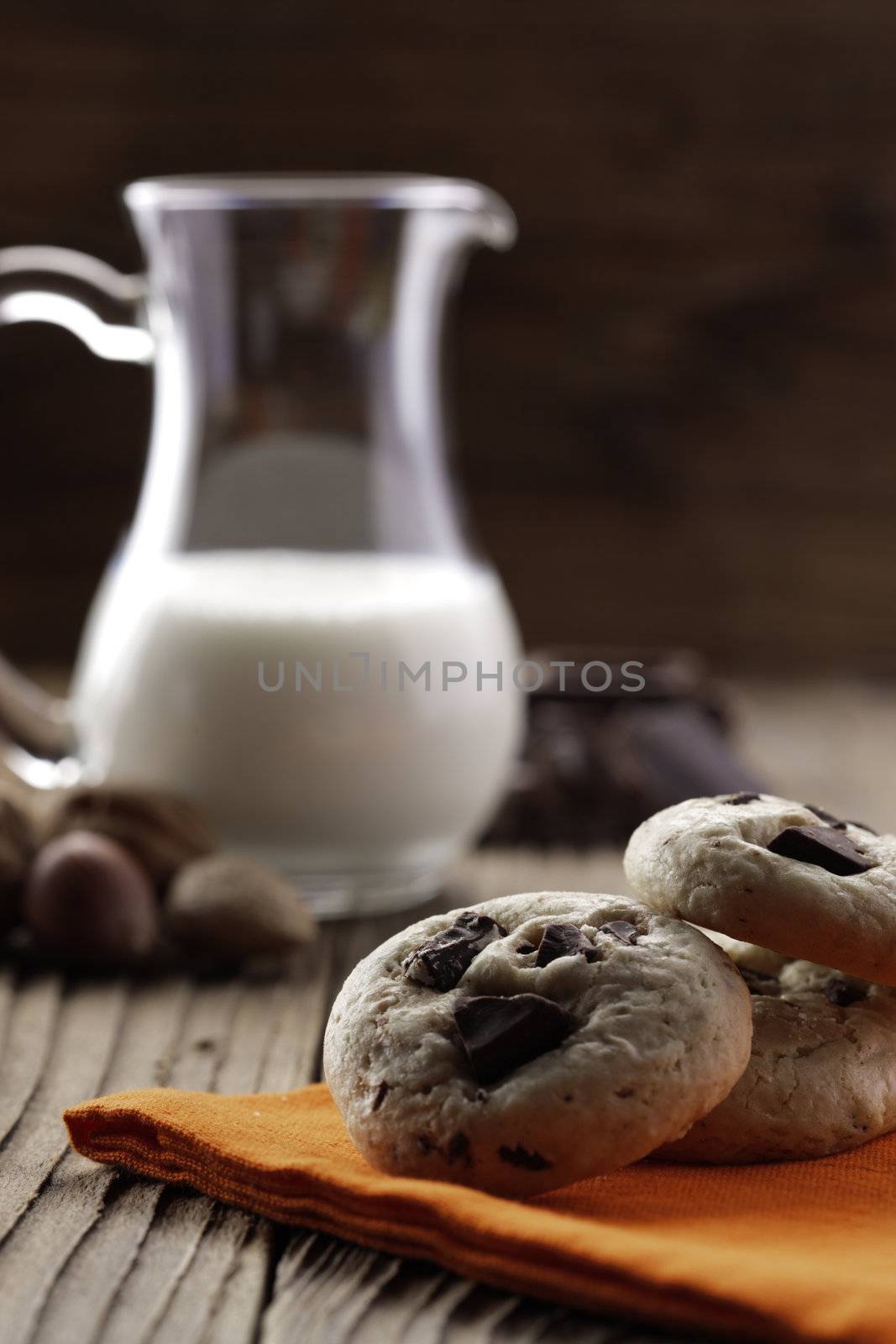 Chocolate chip cookies with ingredients in the background by stokkete