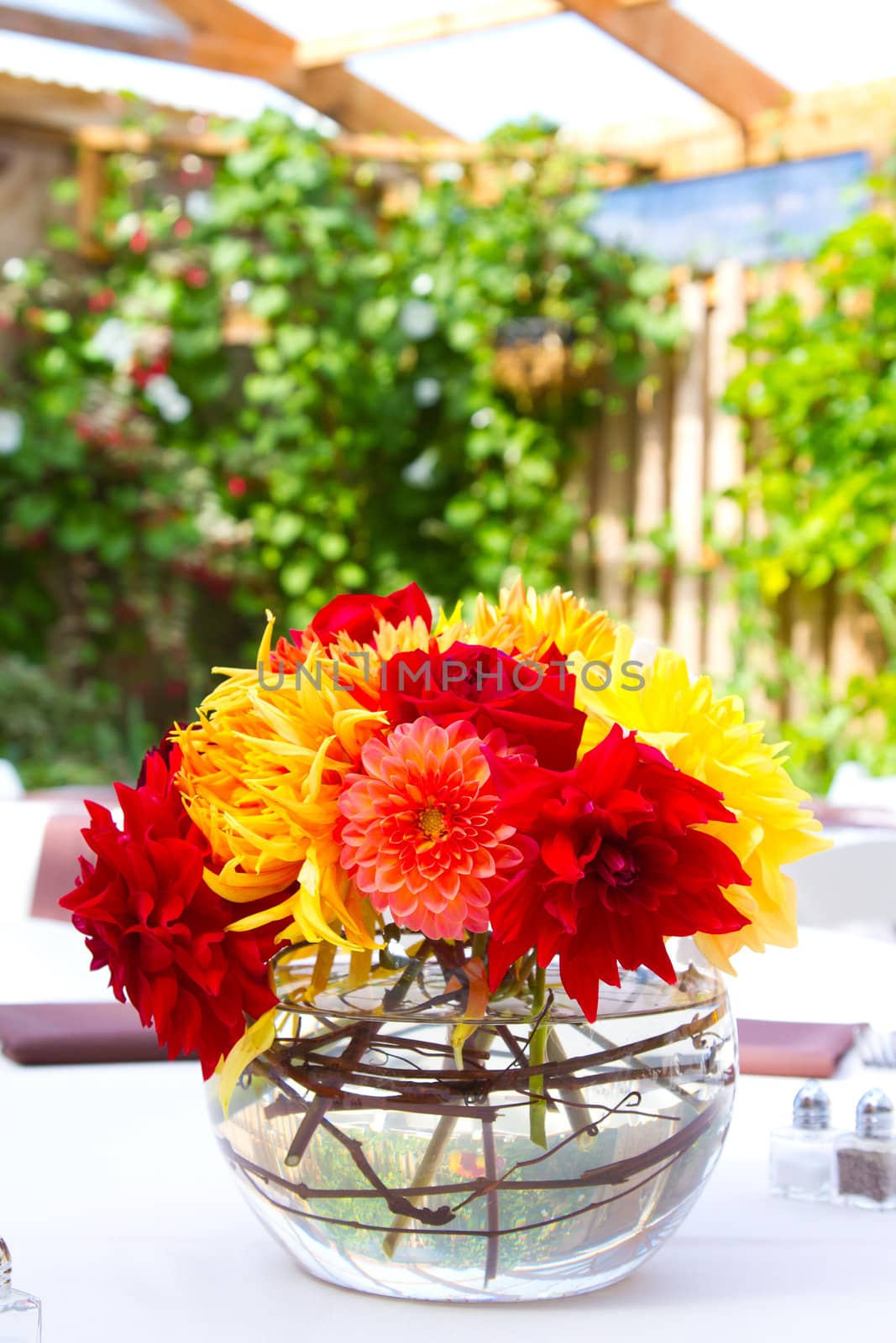 Wedding decor at a ceremony and reception with beautiful red and yellow flowers.