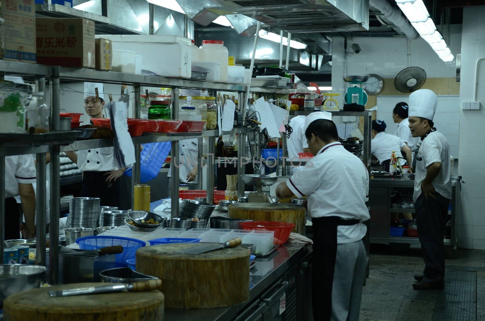 SHENZHEN, CHINA - SEPTEMBER 8: Unidentified Chinese chefs work in kitchen, inside Cantonese style restaurant in Nanshan district on September 8, 2012.