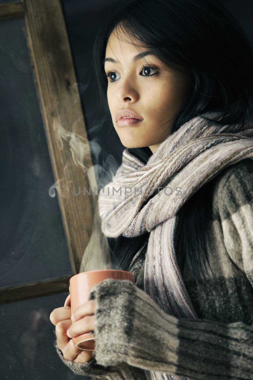 Portrait of a beautiful girl with a cup of coffee or tea